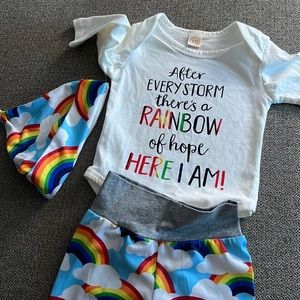Rainbow, baby onesie, and pant set with a cute rainbow hat
